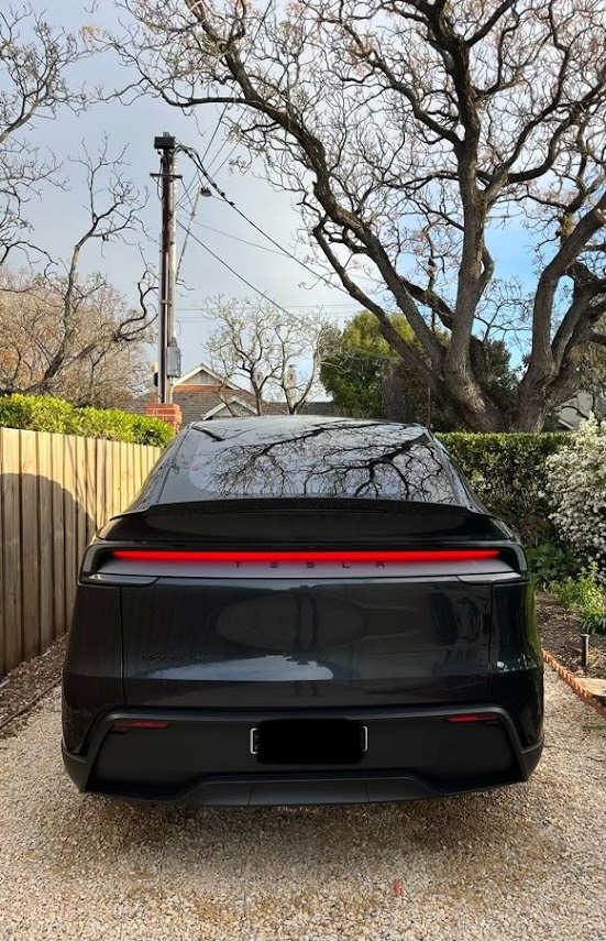 Black Tesla Model Y with a deep gloss finish after detailing